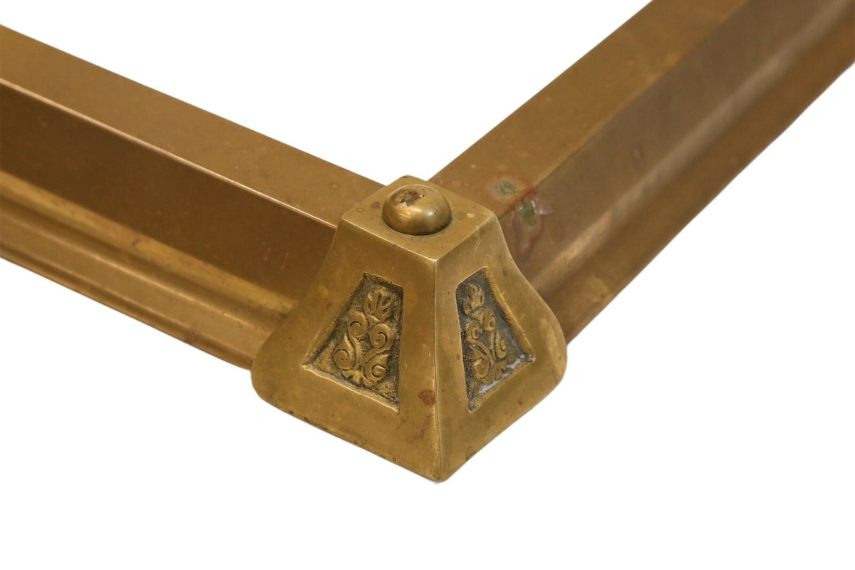 Close-up of cast decoration on the brass fender corner block