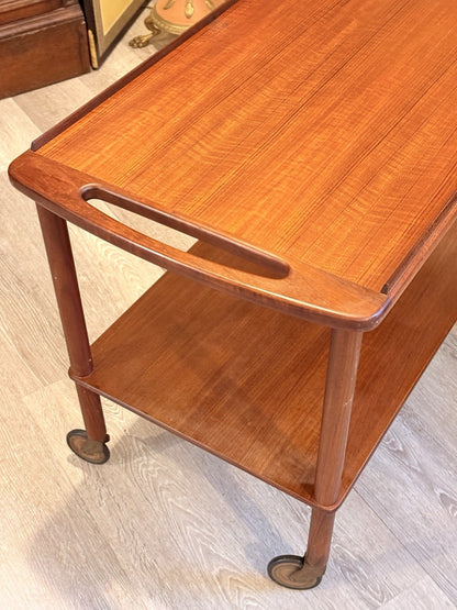 Bowa teak drinks trolley, three-quarter view of handle and lower shelf