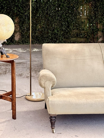 Sage velvet 19th-century sofa, end view beside a side table and floor lamp