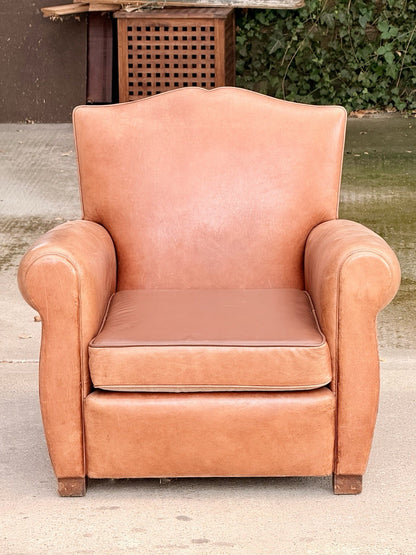 French Art Deco moustache leather club armchair, front view outdoors