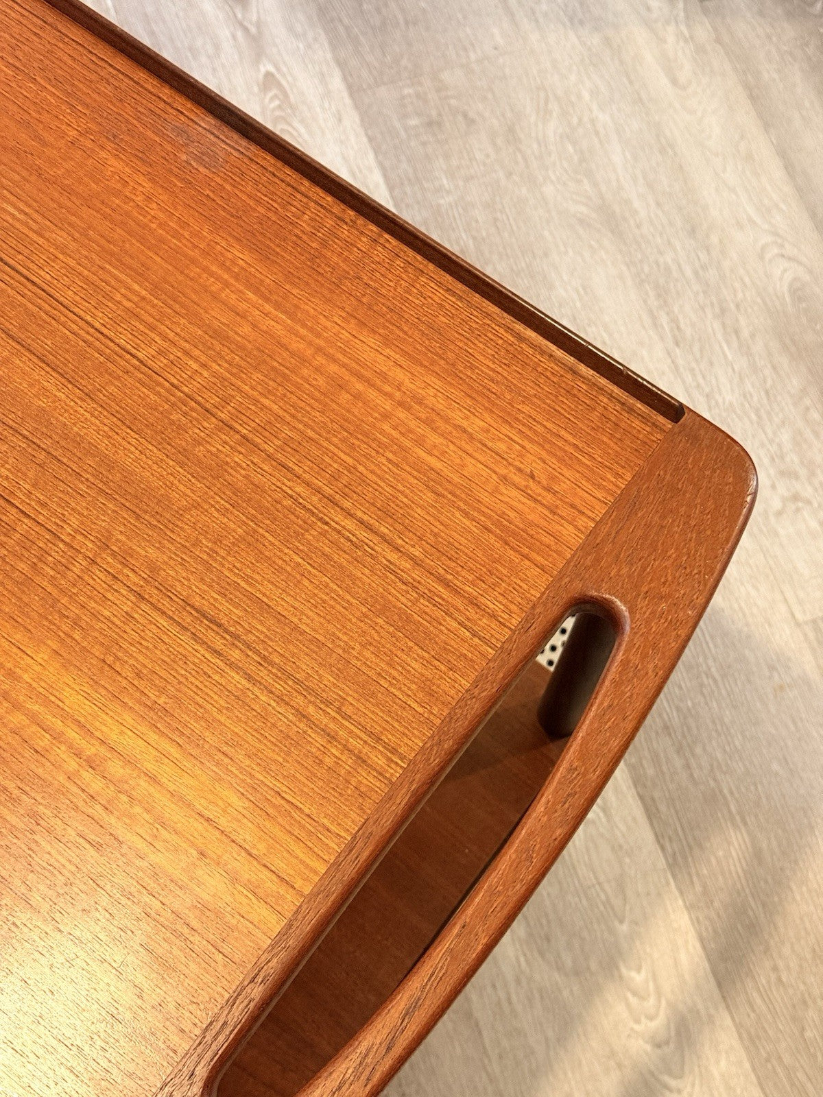 Close-up of teak tray corner and handle cut-out