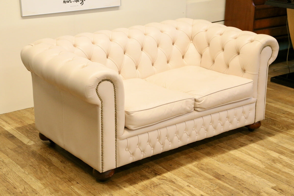 Cream leather Chesterfield 2 seater sofa, three-quarter view