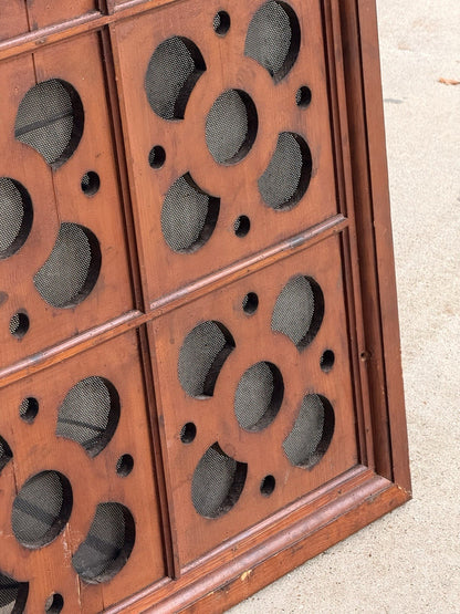 Close-up of pierced roundels and wire mesh, pine ventilation panel
