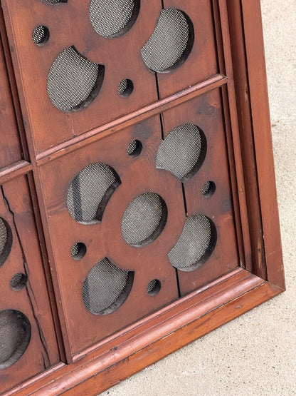 Close-up of pierced roundels and frame edge, pine panel