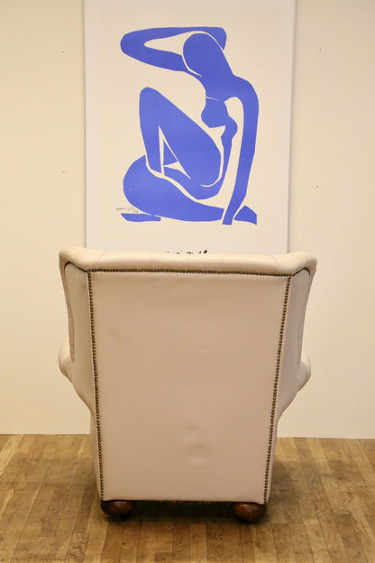 Back view of the cream leather Chesterfield wing chair