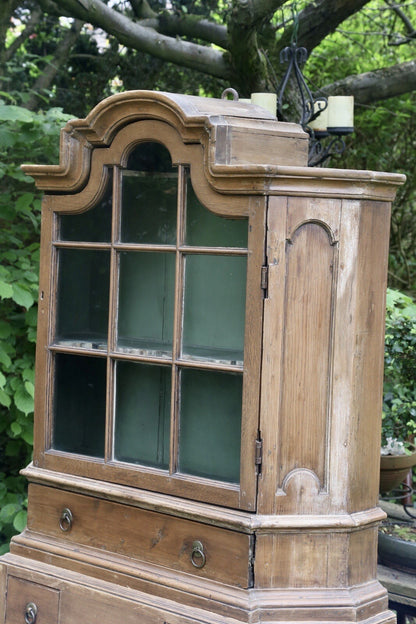 Glazed upper cabinet with arched pediment, pine bookcase, angled view