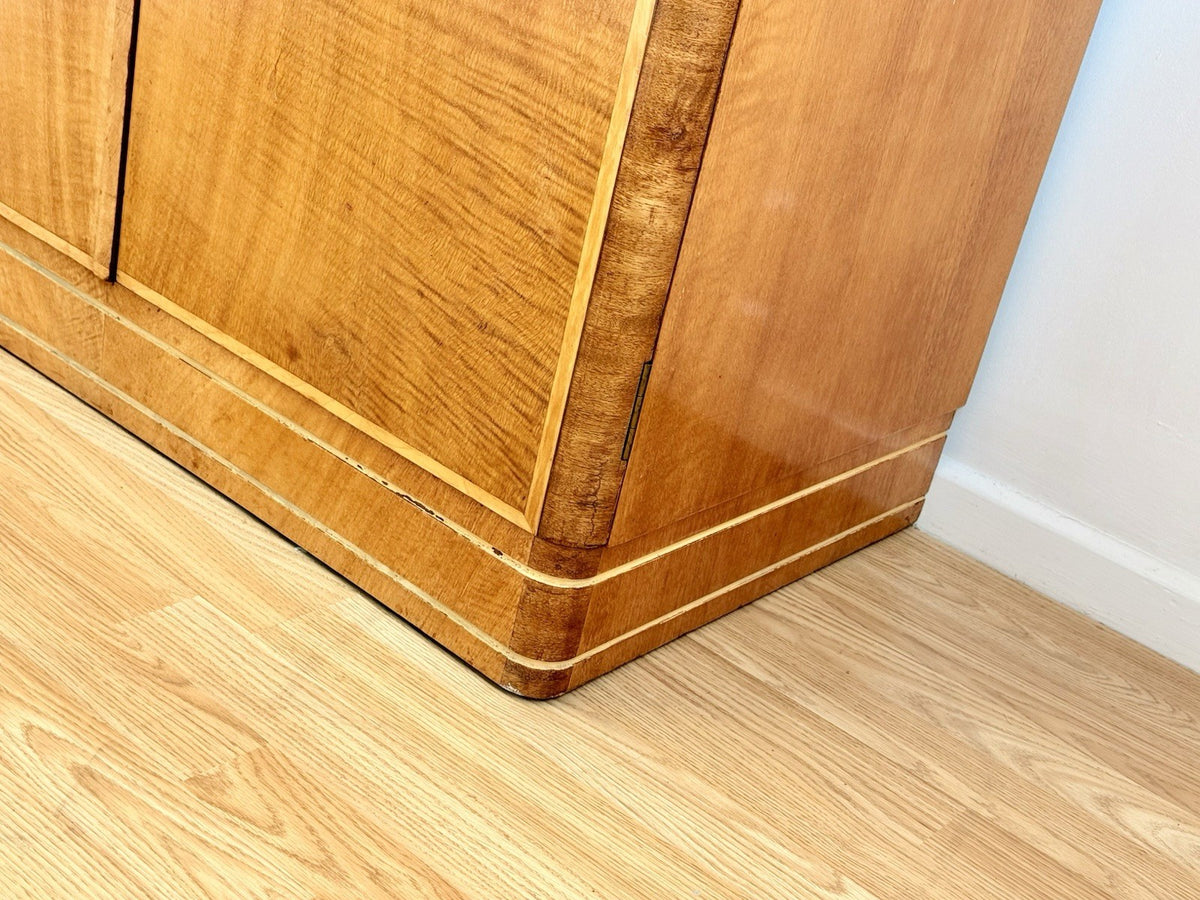 Close-up of wardrobe corner and plinth, bird's eye maple
