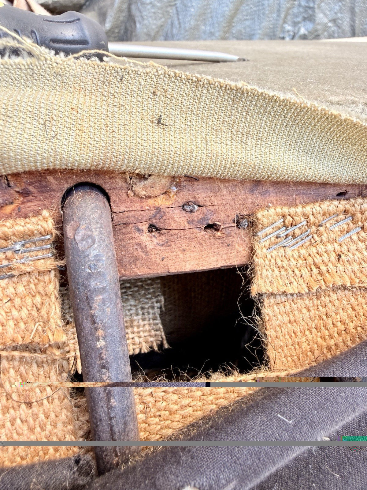 Underside of 19th-century English sofa showing hessian webbing and frame (project piece)