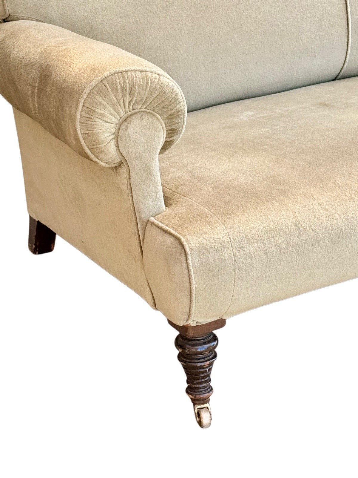 Close-up of scroll arm and turned leg on brass castor, 19th-century English sofa