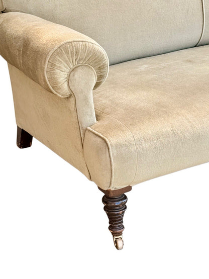 Close-up of scroll arm and turned leg on brass castor, 19th-century English sofa