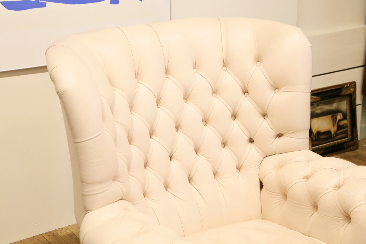 Close-up of deep-buttoned wing back in cream leather