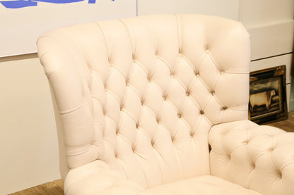 Close-up of deep-buttoned wing back in cream leather