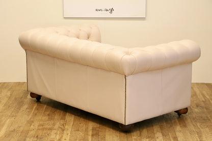 Cream leather Chesterfield 2 seater sofa, rear three-quarter view