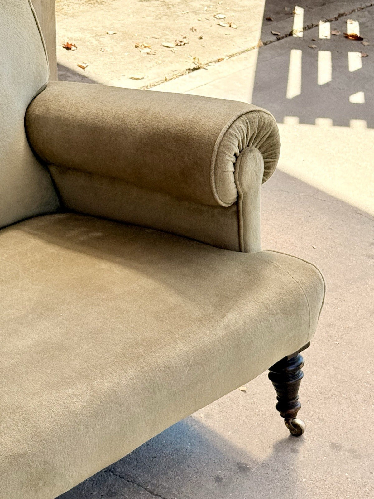 Close-up of rolled arm, seat edge and turned leg, neo-classical sofa