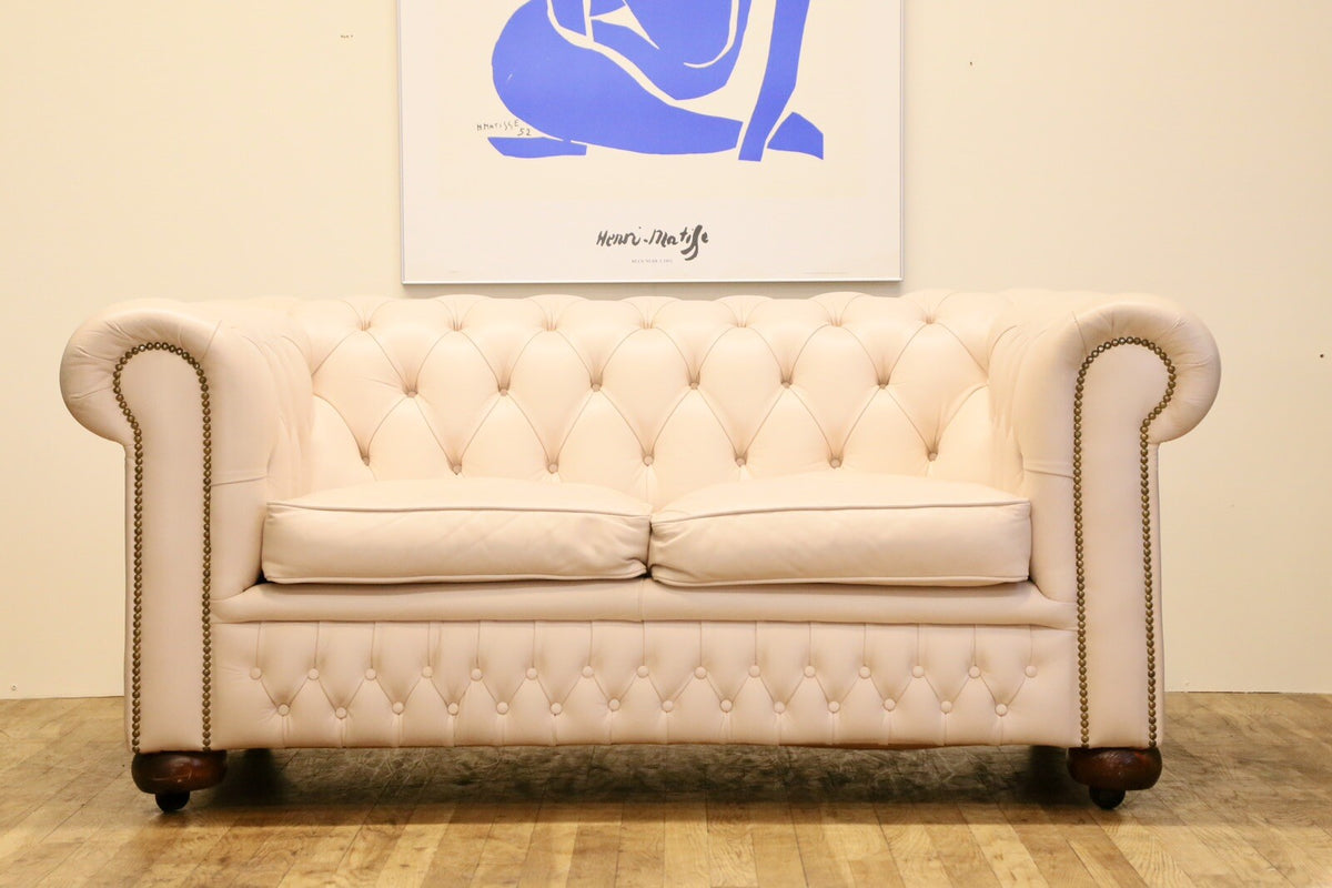 Cream leather Chesterfield 2 seater sofa, low front view