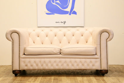 Cream leather Chesterfield 2 seater sofa, low front view