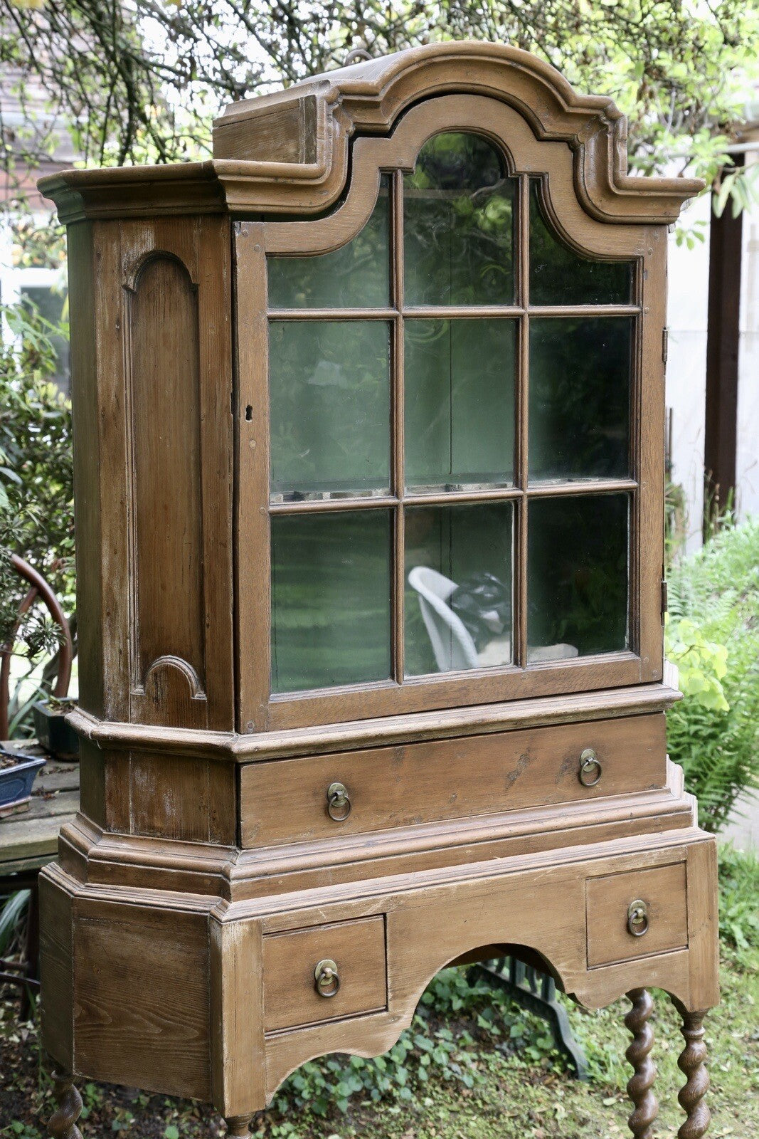 Barley twist pine bookcase on stand, three-quarter view outdoors