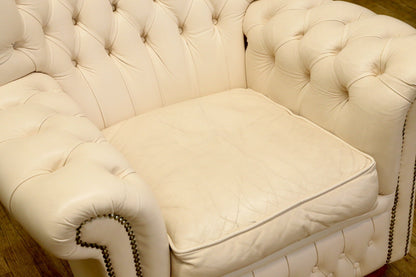 Cream leather seat cushion and buttoned arms from above, wing armchair