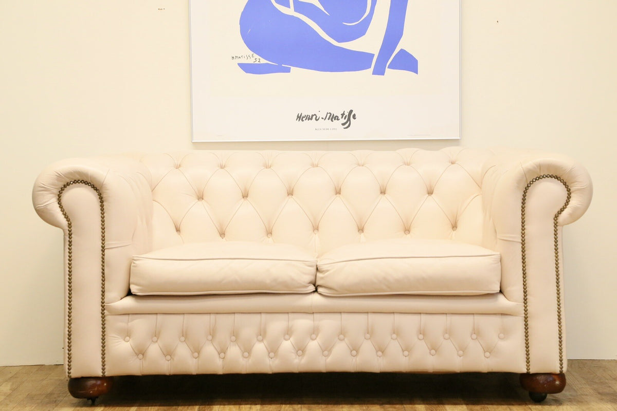 Cream leather Chesterfield 2 seater sofa, full front view