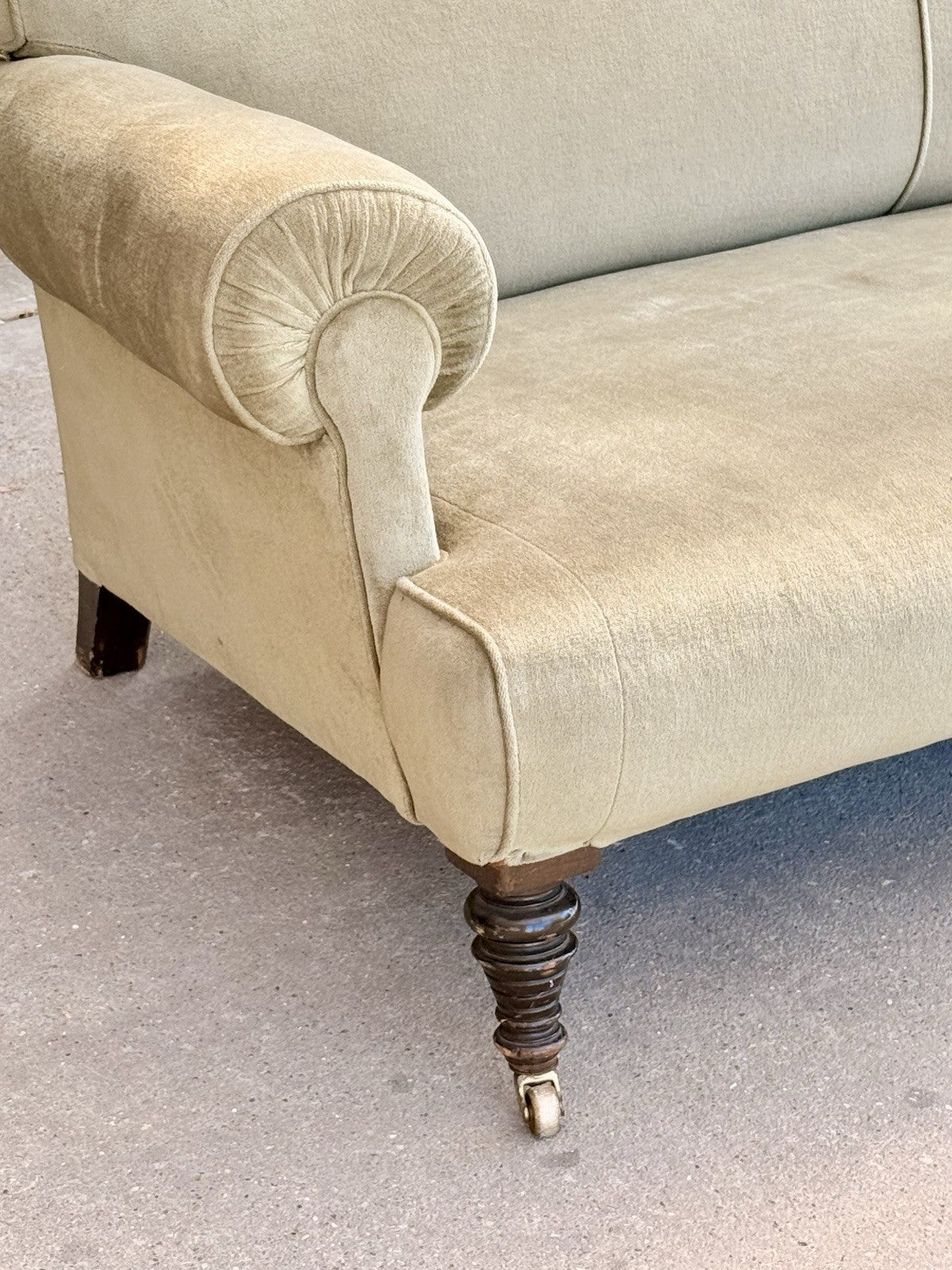 19th-century sofa, close-up of rolled arm and turned mahogany leg