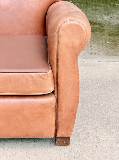 Close-up of rolled leather arm and seat cushion, Art Deco club chair