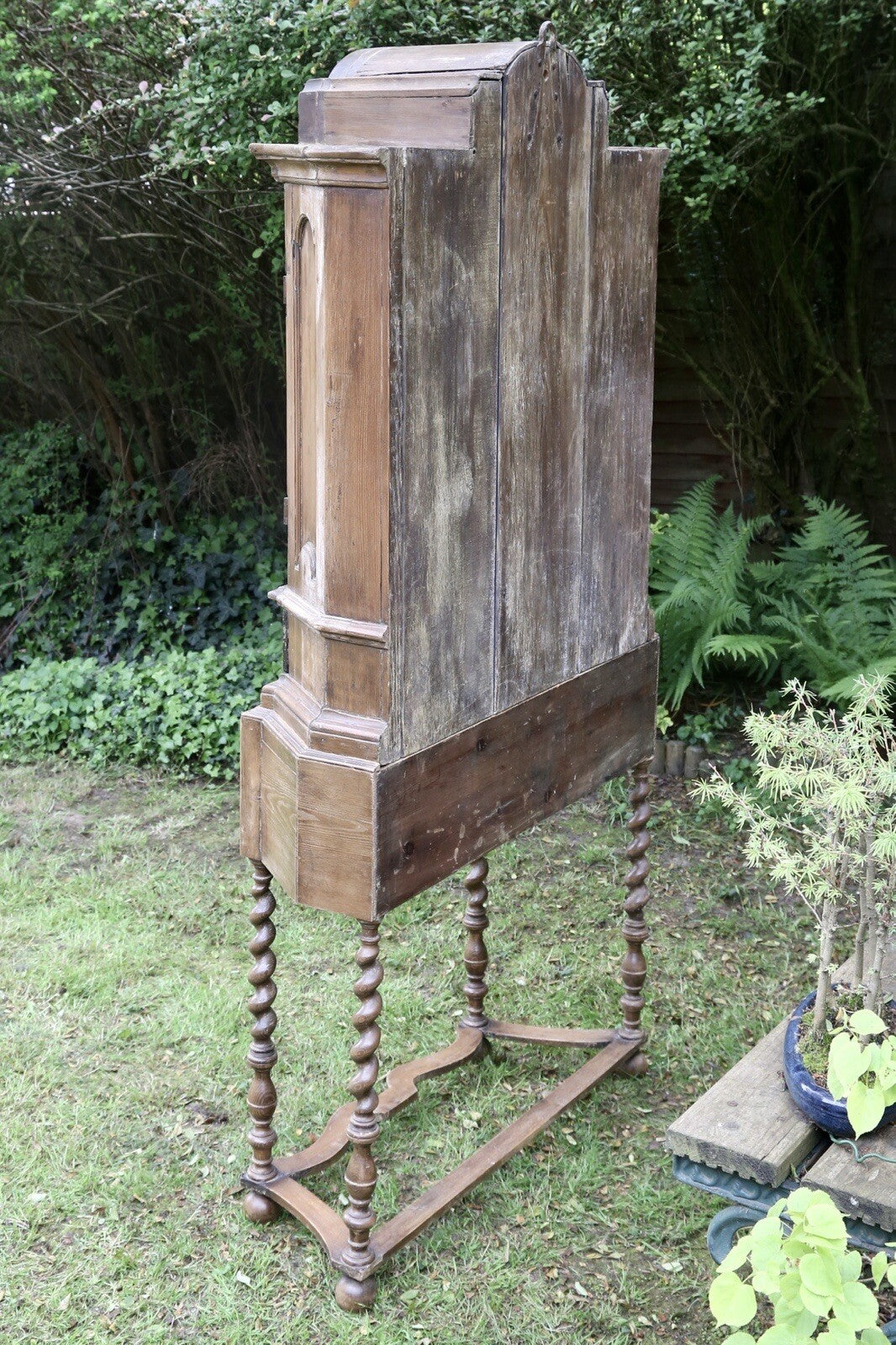 Rear three-quarter view of the barley twist pine bookcase on stand