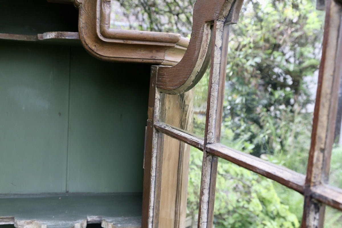 Close-up of glazed door open, green painted interior
