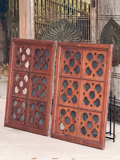 Pair of architectural antique carved pine ventilation panels with pierced quatrefoil cutouts and mesh backing