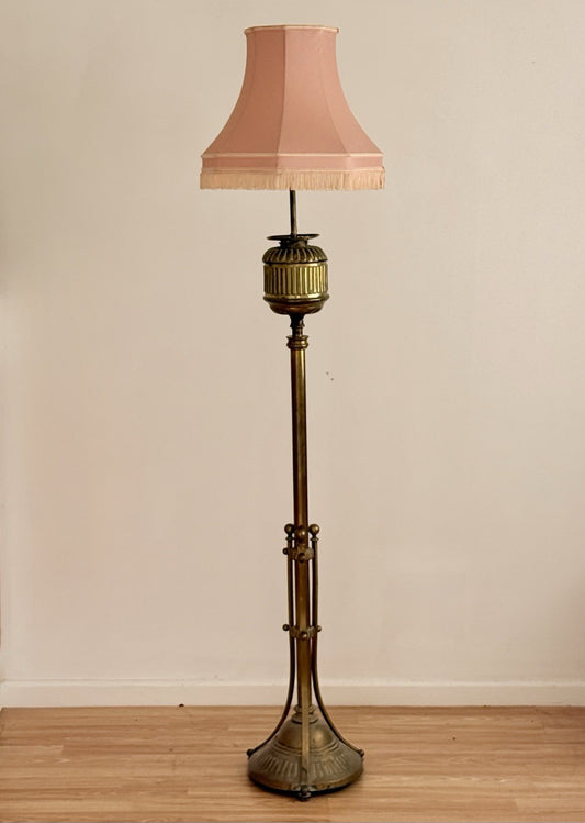 Hine & Co tall brass floor lamp, electrified standard oil lamp with fluted urn top, tripod base and pink pleated shade