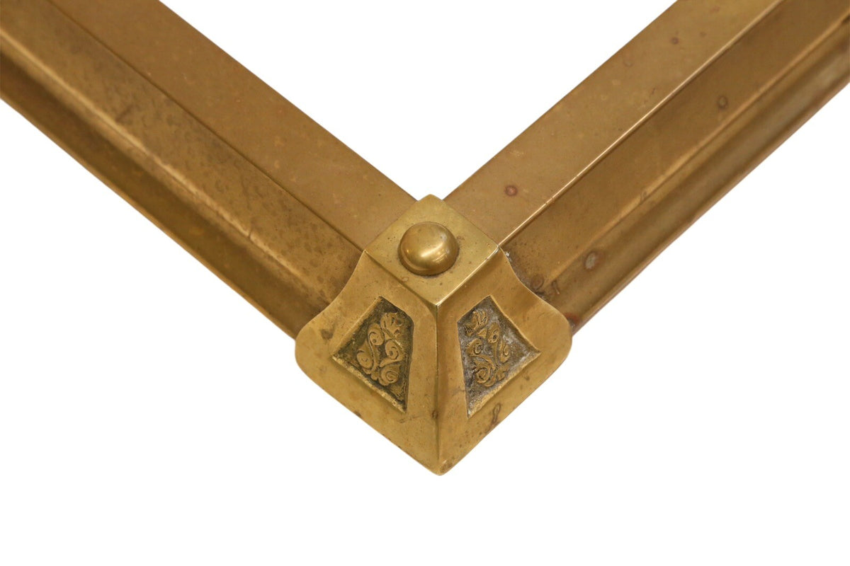 Close-up of brass fender corner block with domed finial