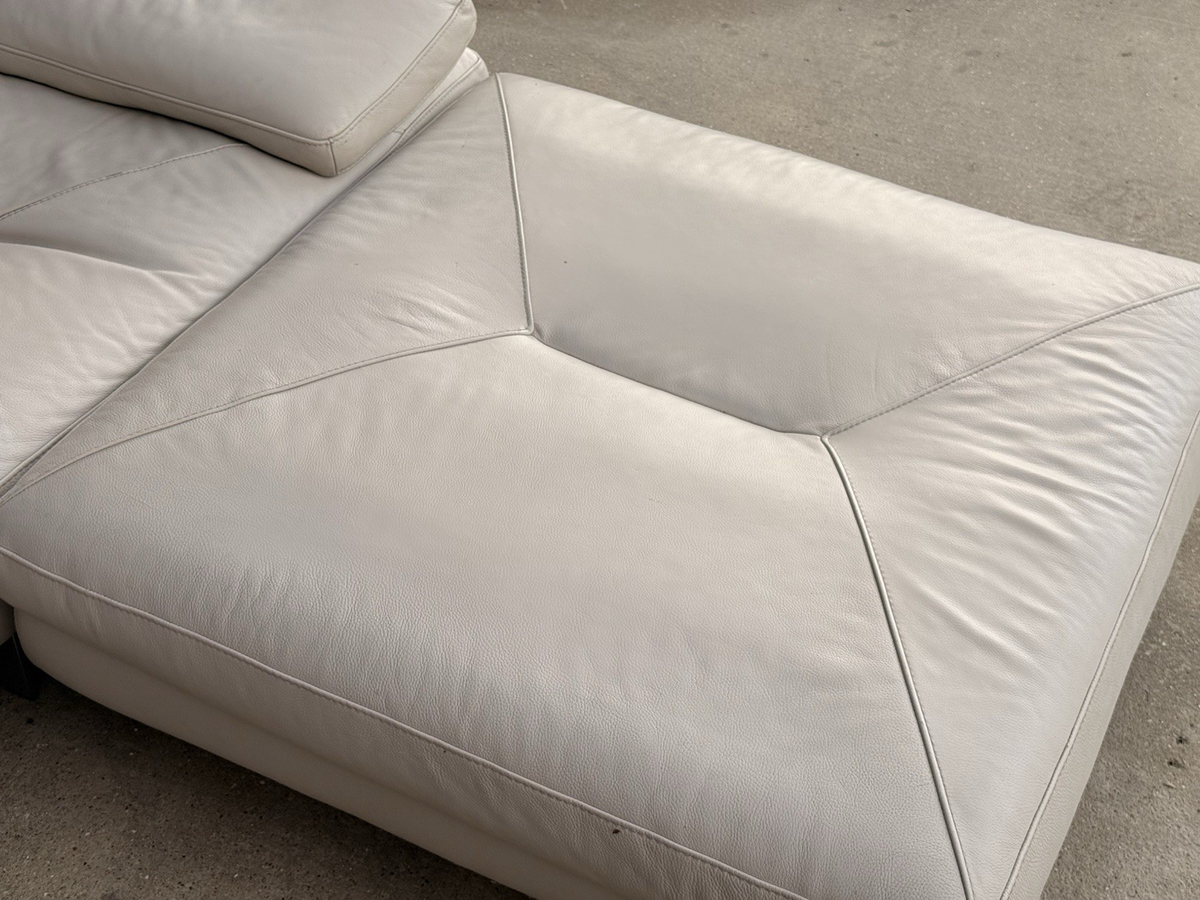 Close-up of stitched ivory leather ottoman top