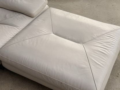 Close-up of stitched ivory leather ottoman top