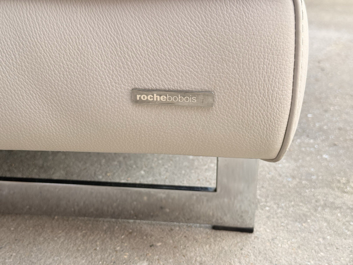 Close-up of Roche Bobois badge and polished metal leg