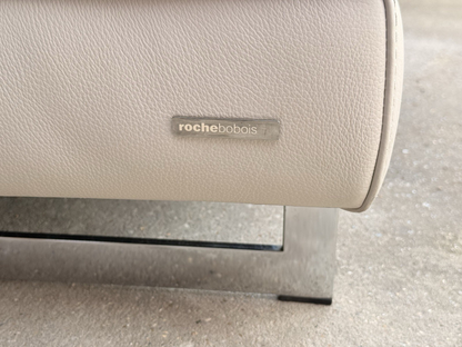 Close-up of Roche Bobois badge and polished metal leg
