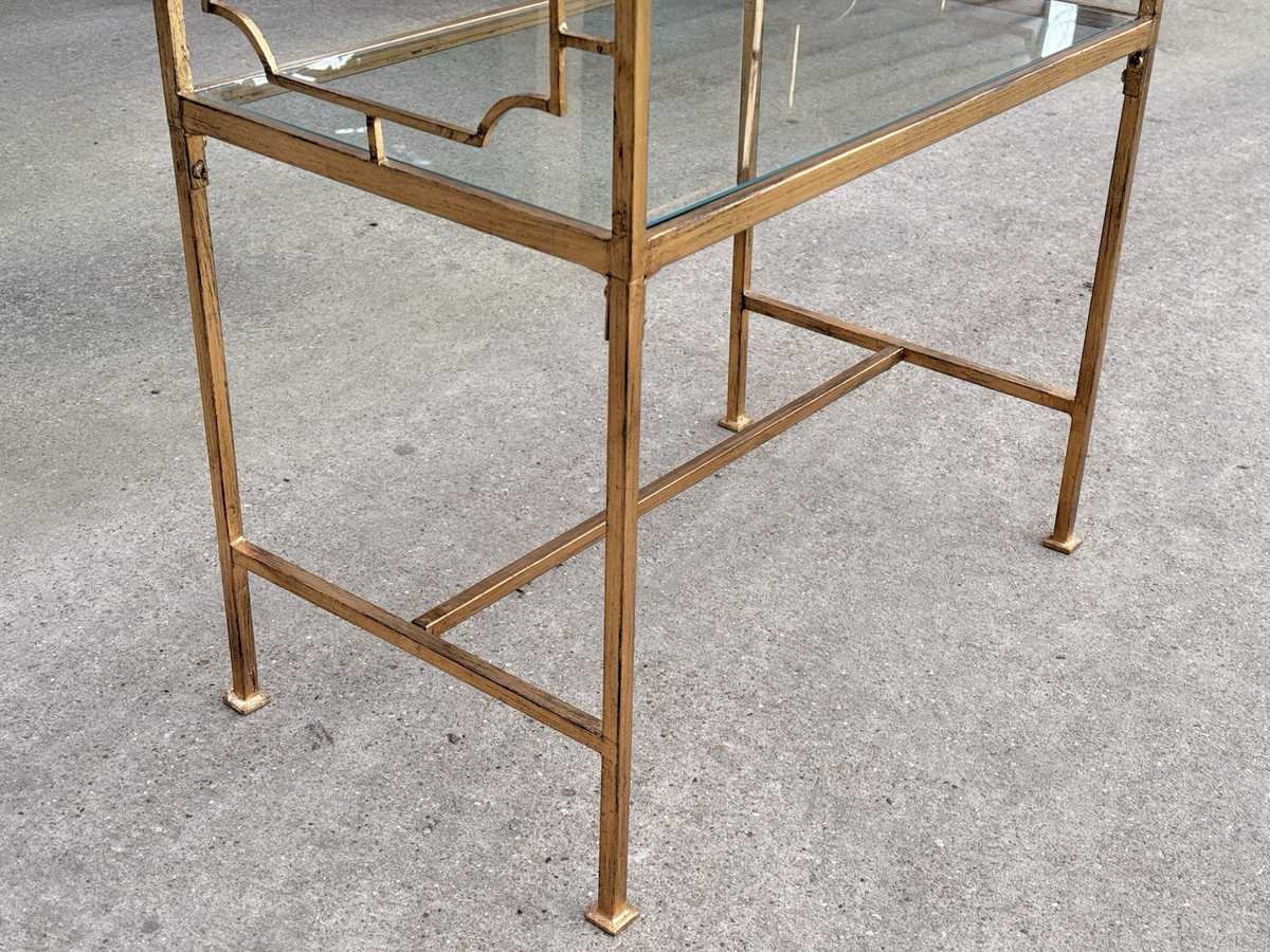 Close-up of slim gilded legs and lower stretcher