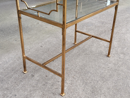 Close-up of slim gilded legs and lower stretcher