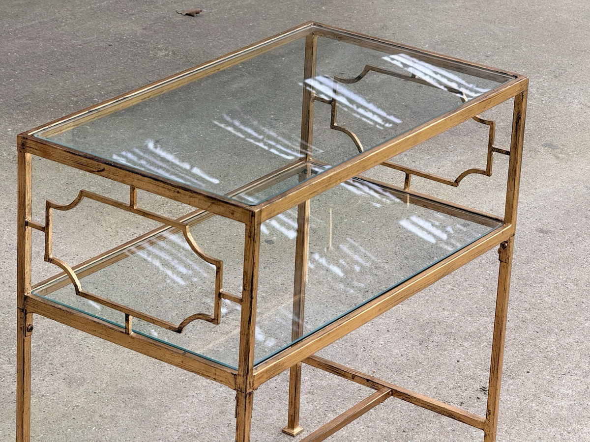 Close-up of glass tiers and gold fretwork sides