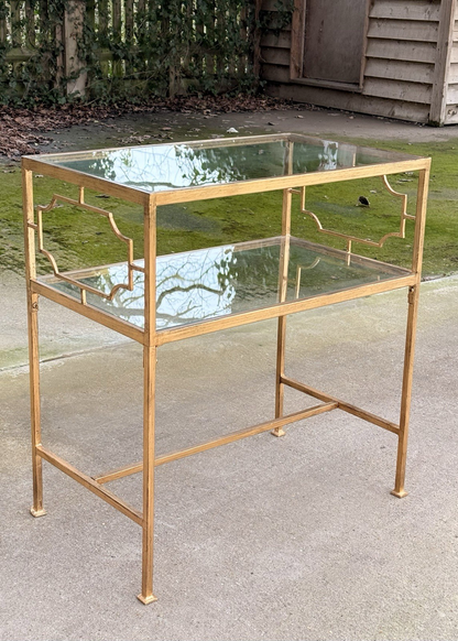 Uttermost Genell gold two-tier glass side table, front view outdoors