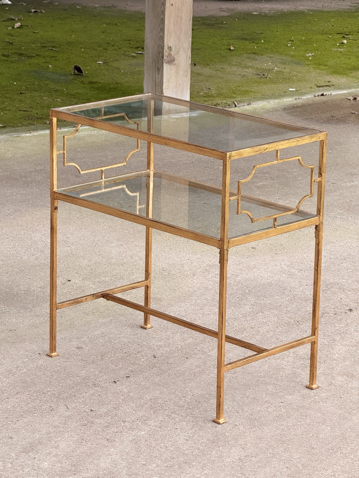Uttermost Genell gold two-tier glass side table, three-quarter view