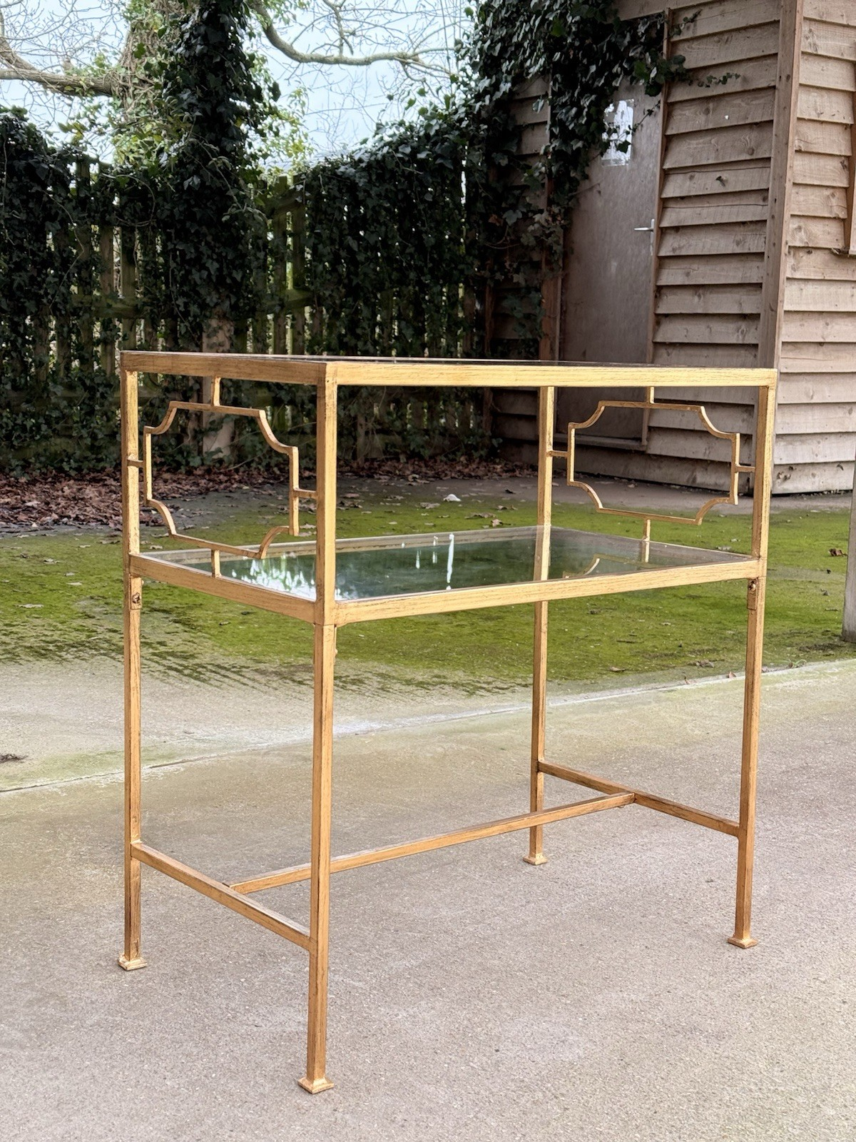 Uttermost Genell gold two-tier glass side table, end view