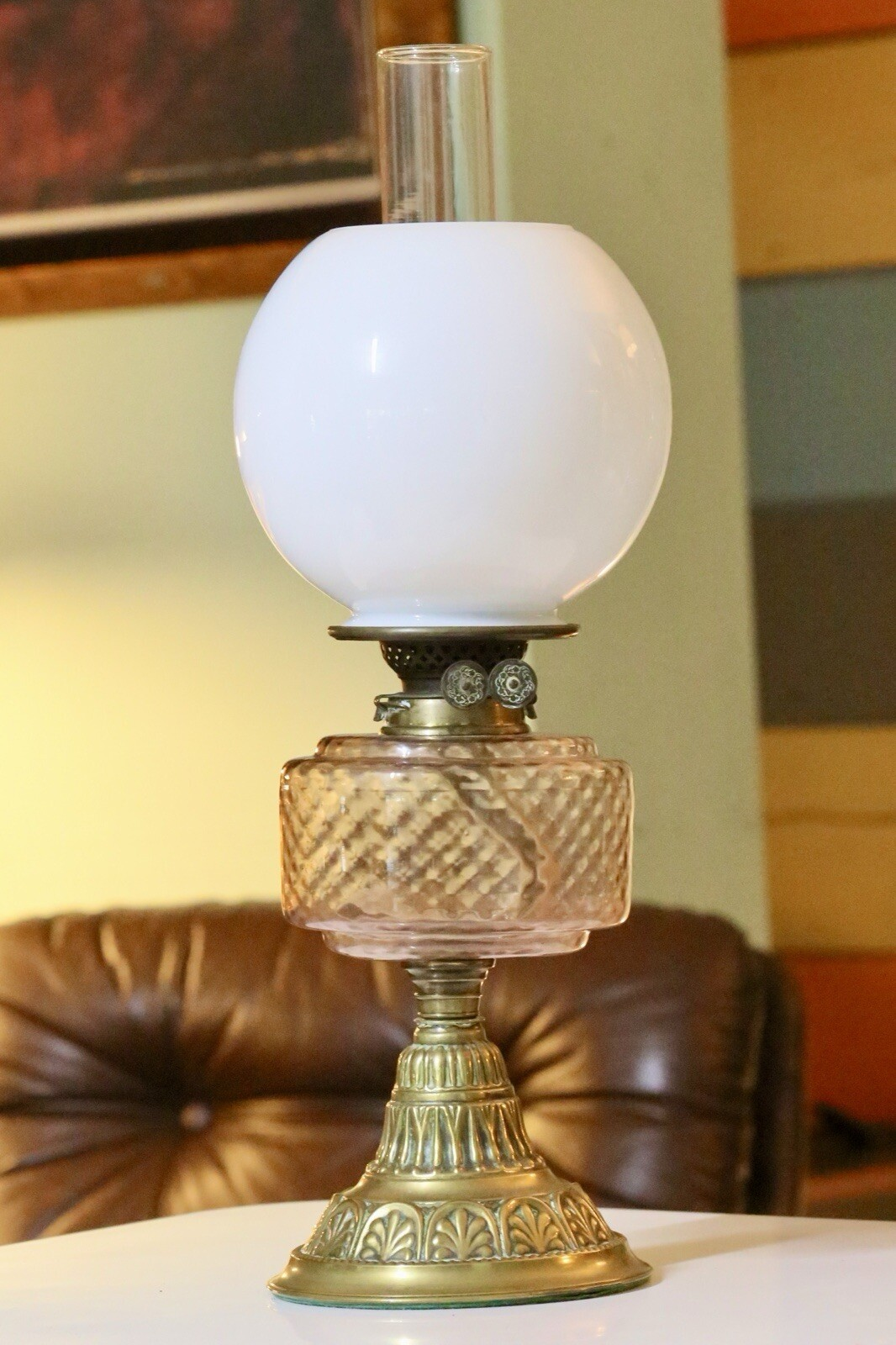 Victorian Art Nouveau brass oil lamp with pink glass reservoir, front view