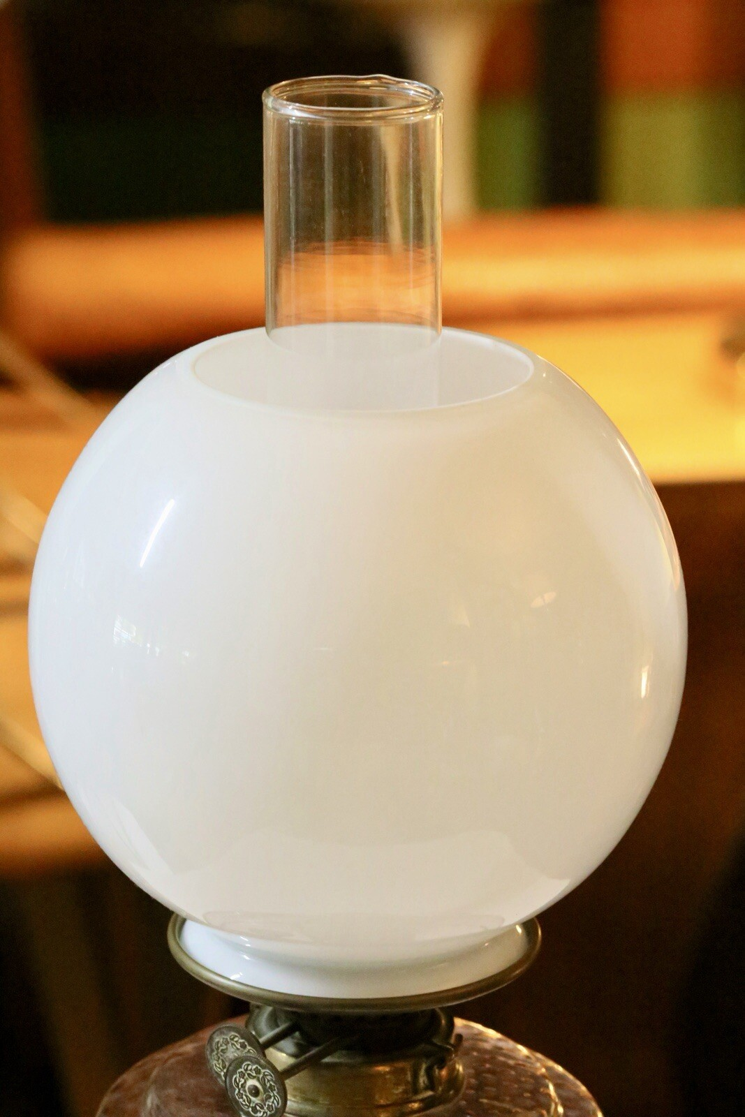 Close-up of white opaline globe shade and glass chimney
