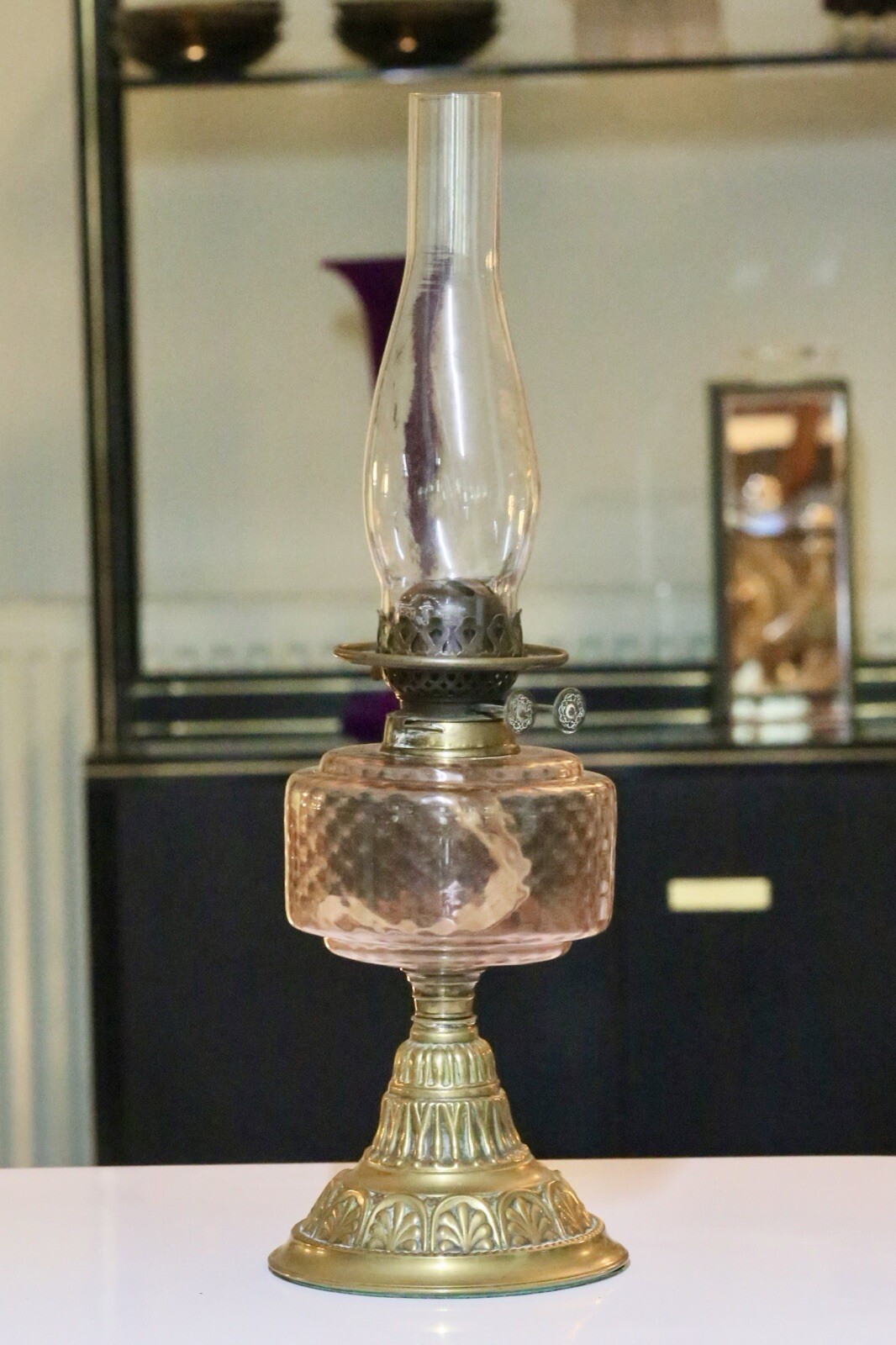 Victorian Art Nouveau brass oil lamp with pink glass reservoir with clear chimney, shade removed