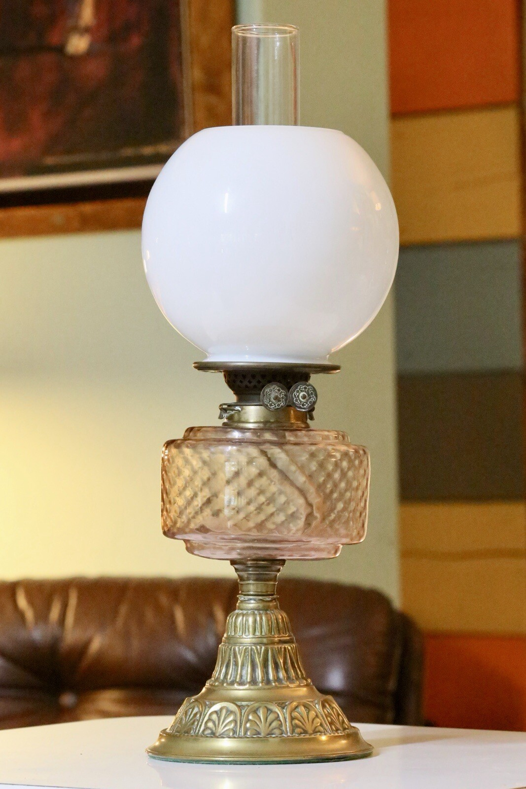 Victorian Art Nouveau brass oil lamp with pink glass reservoir, white opaline globe shade and embossed brass base, 54cm