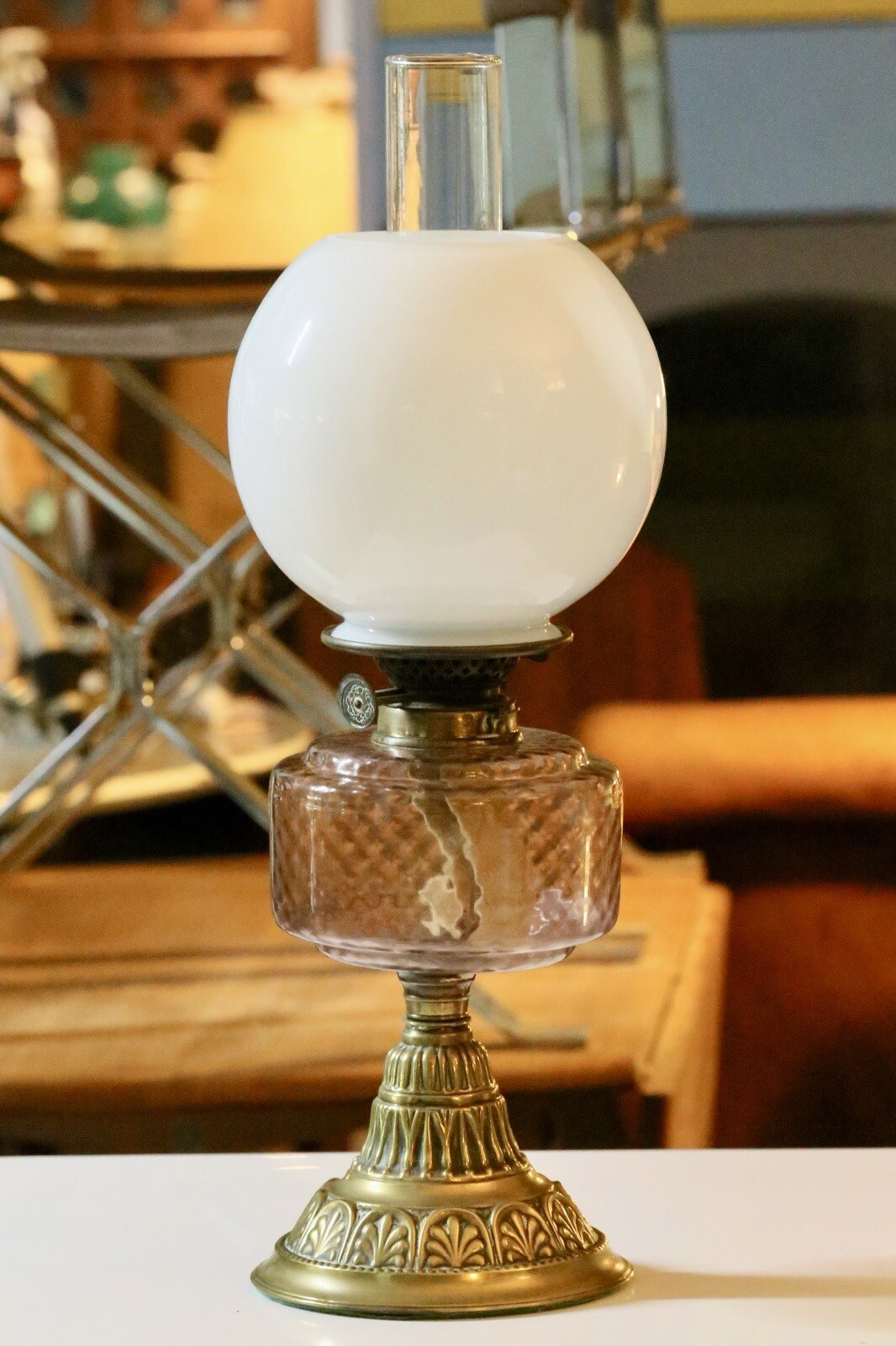 Victorian Art Nouveau brass oil lamp with pink glass reservoir, three-quarter view