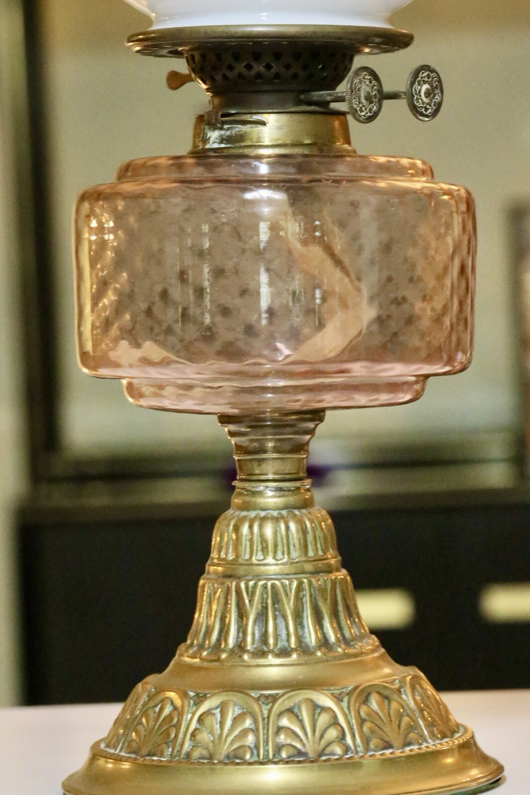Close-up of pink glass font and burner, Victorian oil lamp