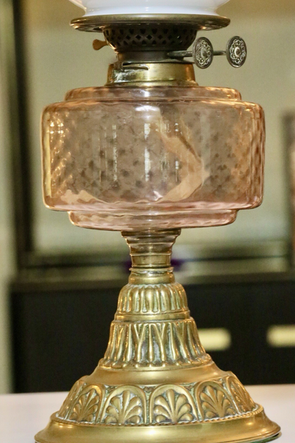 Close-up of pink glass font and burner, Victorian oil lamp