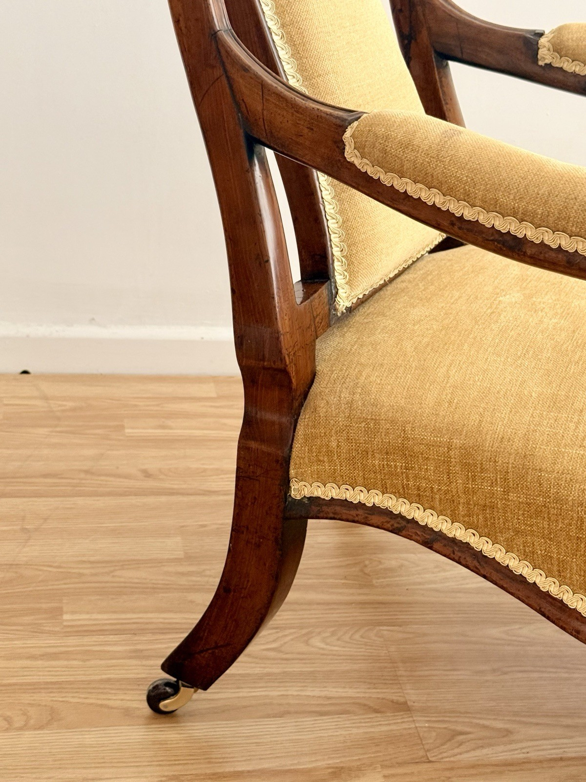 Close-up of rosewood arm and rear leg with caster