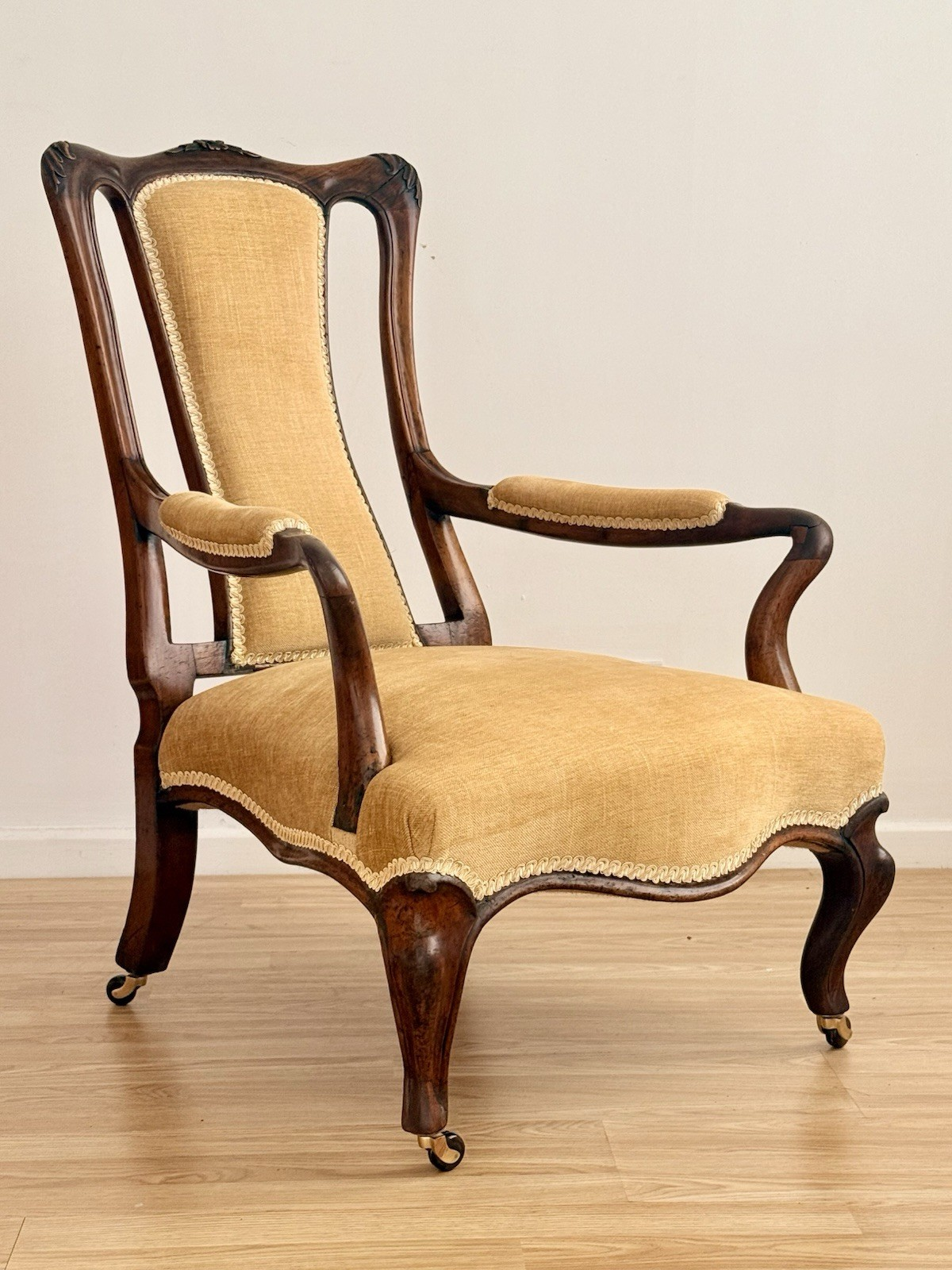 Victorian carved rosewood lounge armchair, three-quarter view
