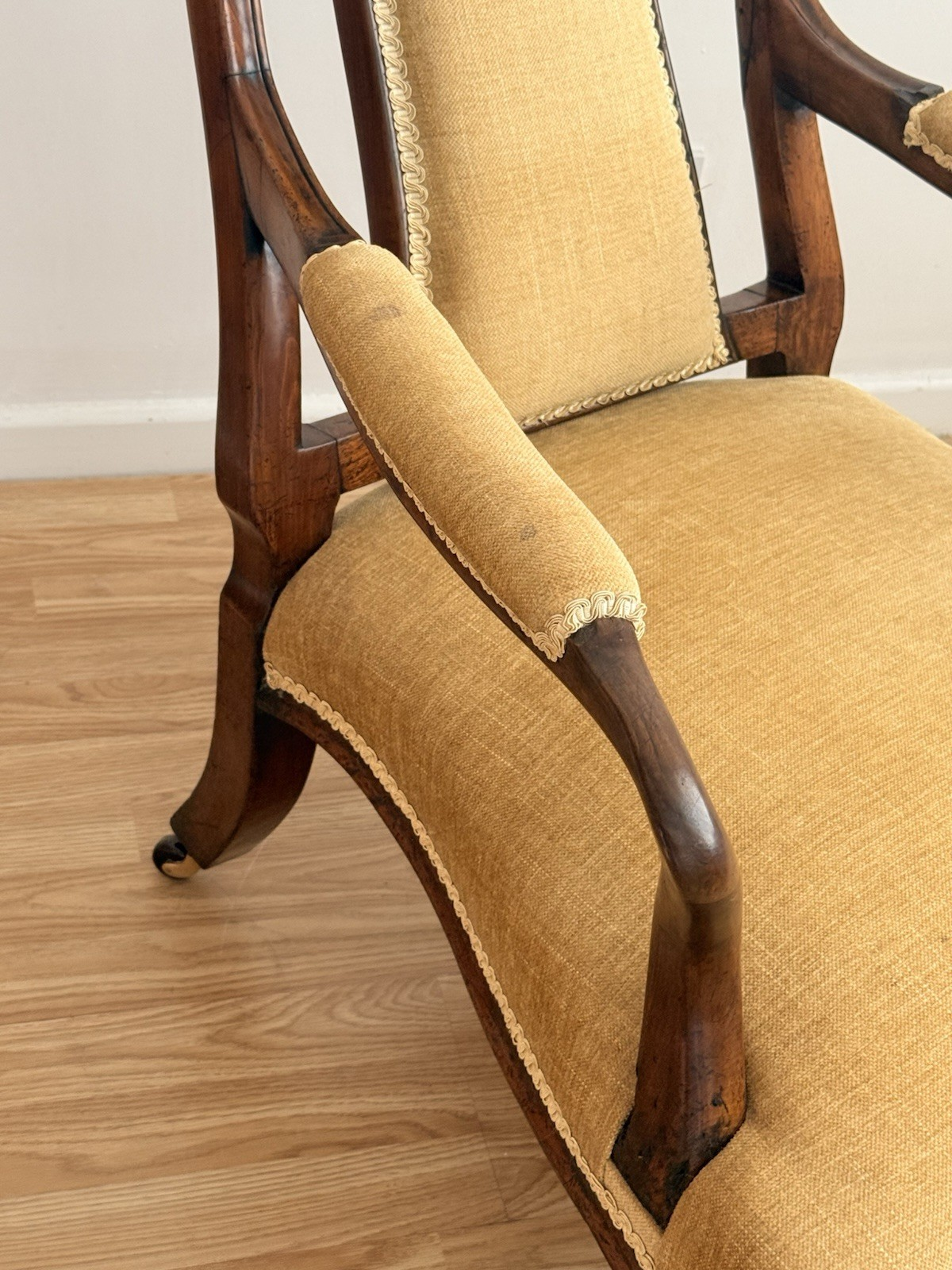 Close-up of padded arm and golden upholstered seat